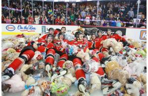 Calgary Hitmen surrounded by teddy bears on the ice. Photo by Gavin Young, Calgary Herald.