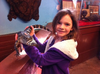 Avery holds an alligator.