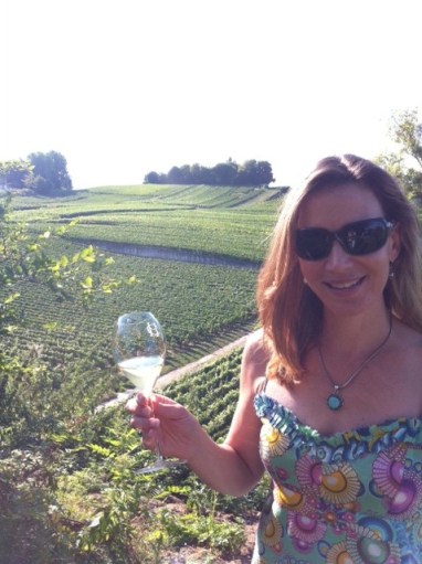 The newly-minted chatelaine sips champagne at a vineyard in Champagne. 