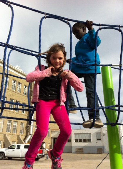 Avery takes a rest on the rope bridge.