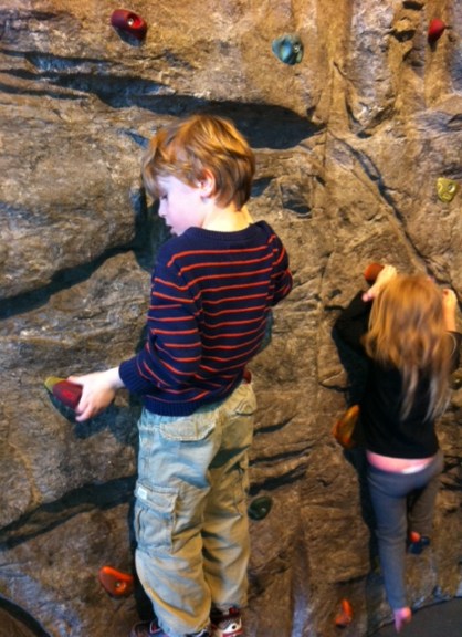 Bennett tries the climbing wall at Telus Spark.