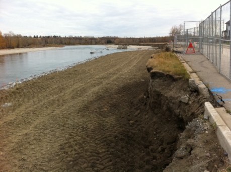 Crews reclaimed new bank with dirt, gravel and riprap.