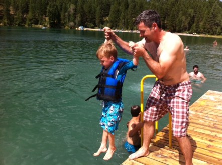 Blake lowers Bennett into Surveyor's Lake near Fernie in 2013. 