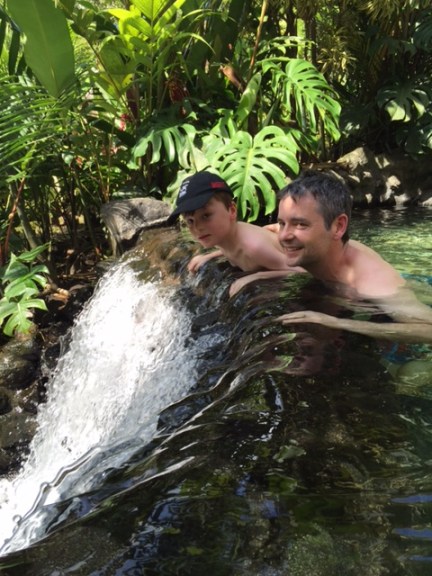 Bennett and Blake peer over a waterfall at Tabacon Grand Spa Thermal Resort.