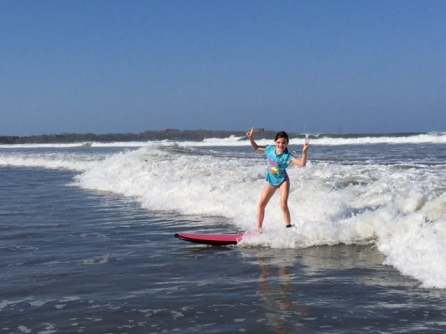 Avery is all confidence on her surf board, mugging for the camera.
