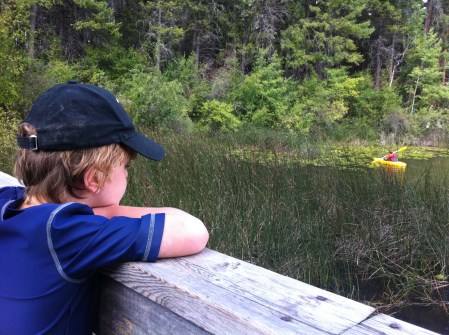 Bennett pauses on the bridge between Surveyor's Lake and Engineer's Lake to look for turtles swimming in the water or sunning on logs on our regular hike.