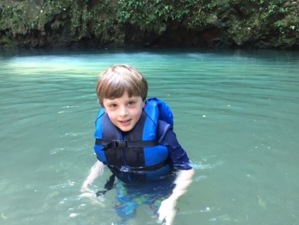 Bennett swims in a cenote (limestone sink hole filled with water) that's in a national park just a 15-minute walk from Caves Branch.